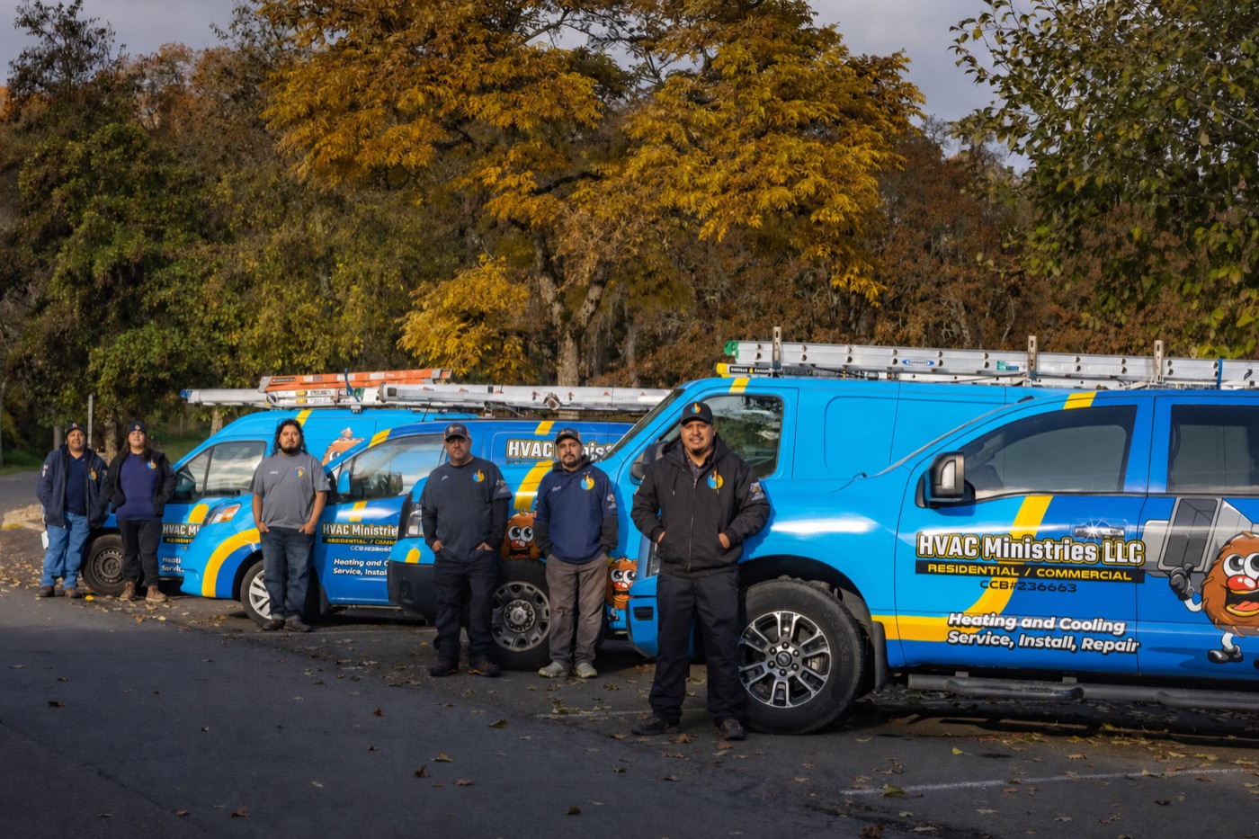 The HVAC Ministries team with their service vehicles